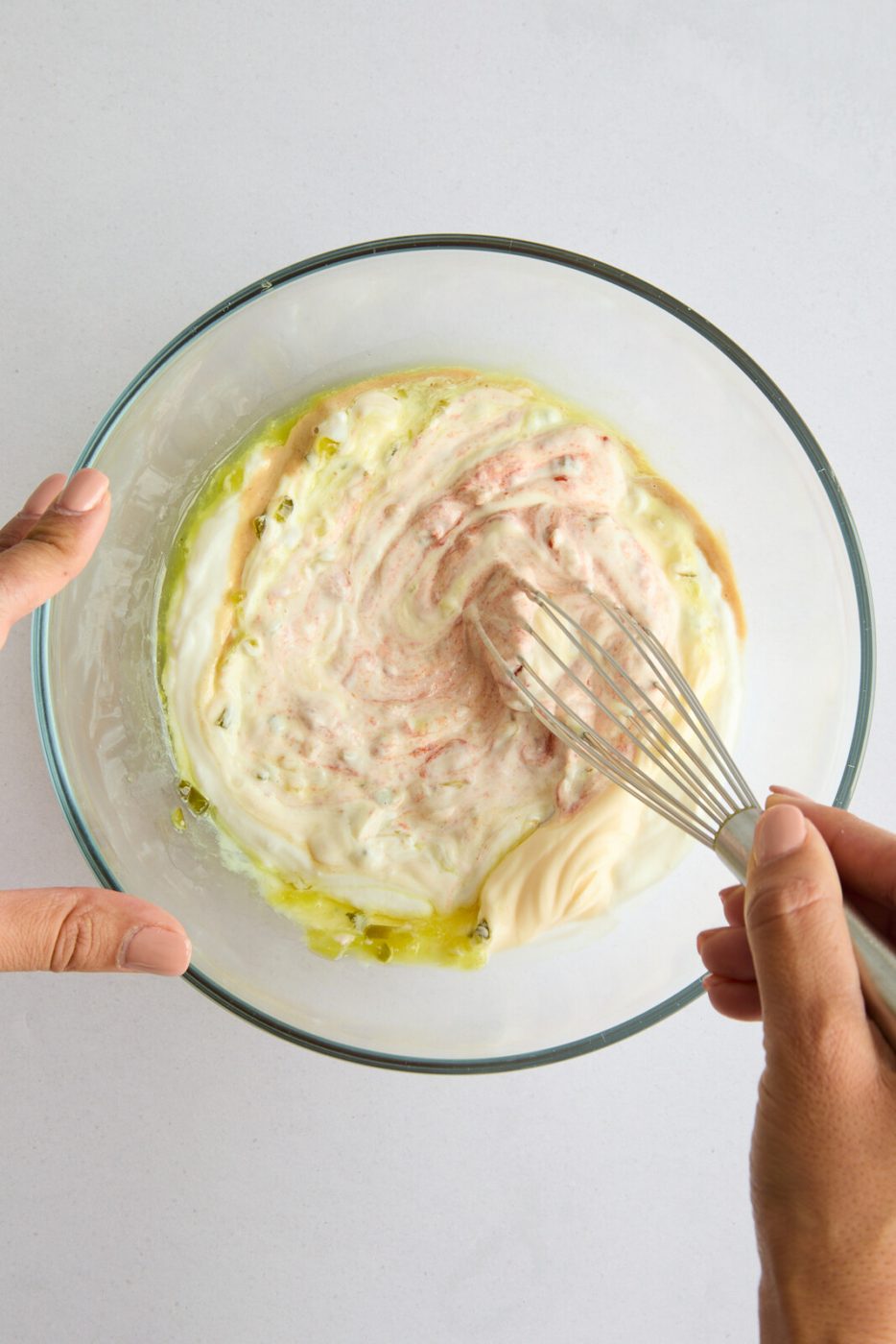 An image whisking the ingredients for the sauce. 