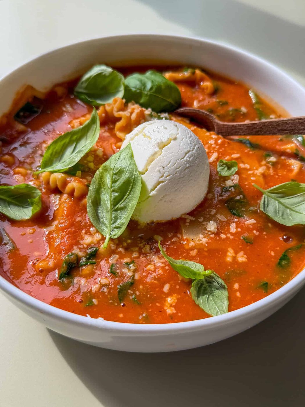 High fibre lasagna soup in a bowl with a dollop of ricotta on top