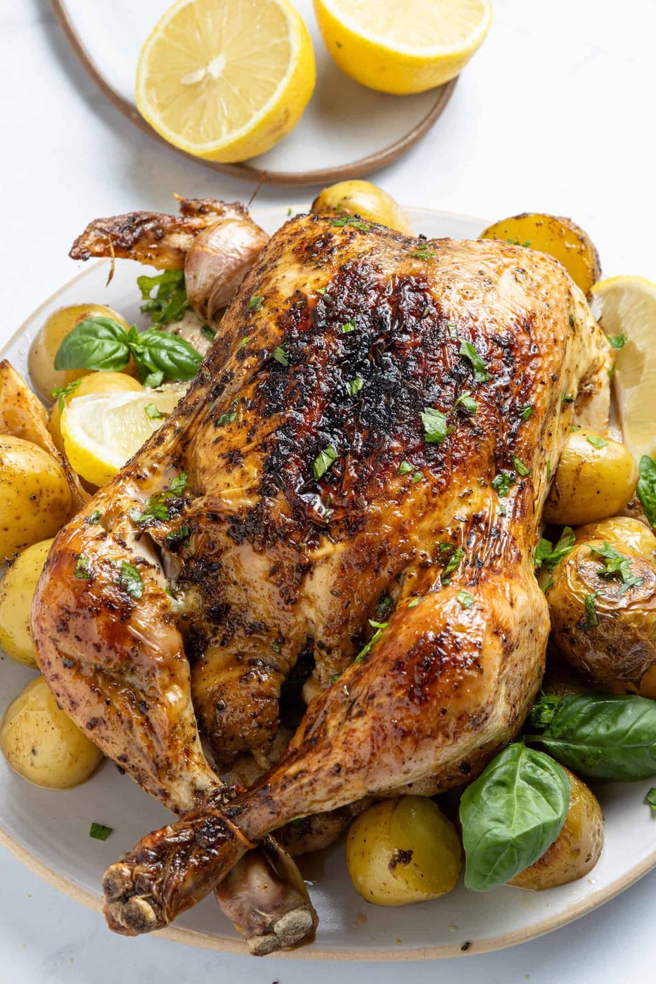 Image of whole Roasted Chicken & Potatoes on a plate. 