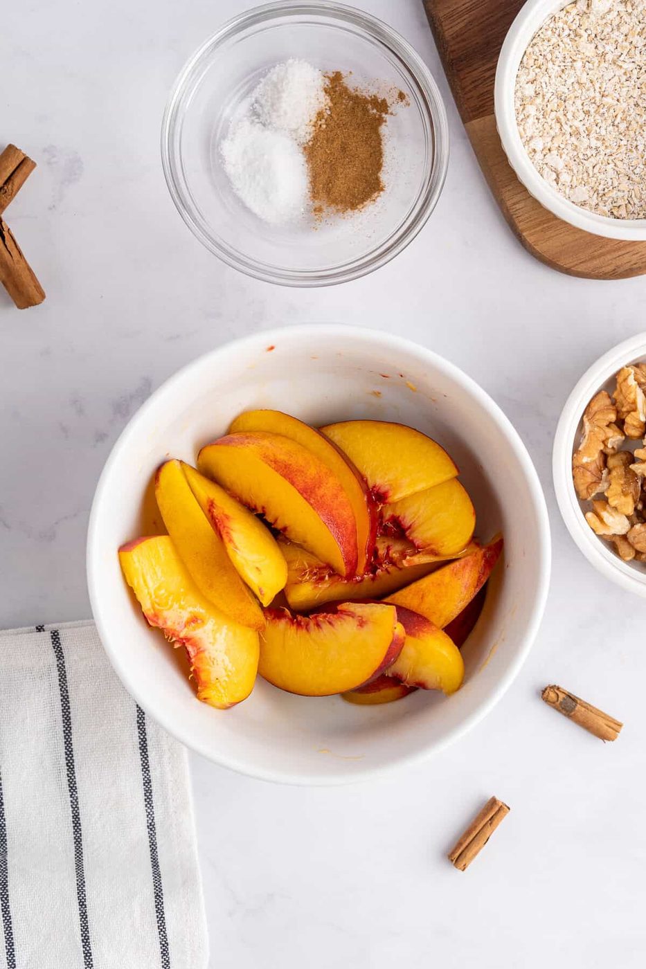 a photo of freshly cut peaches in the bottom of a ramekin