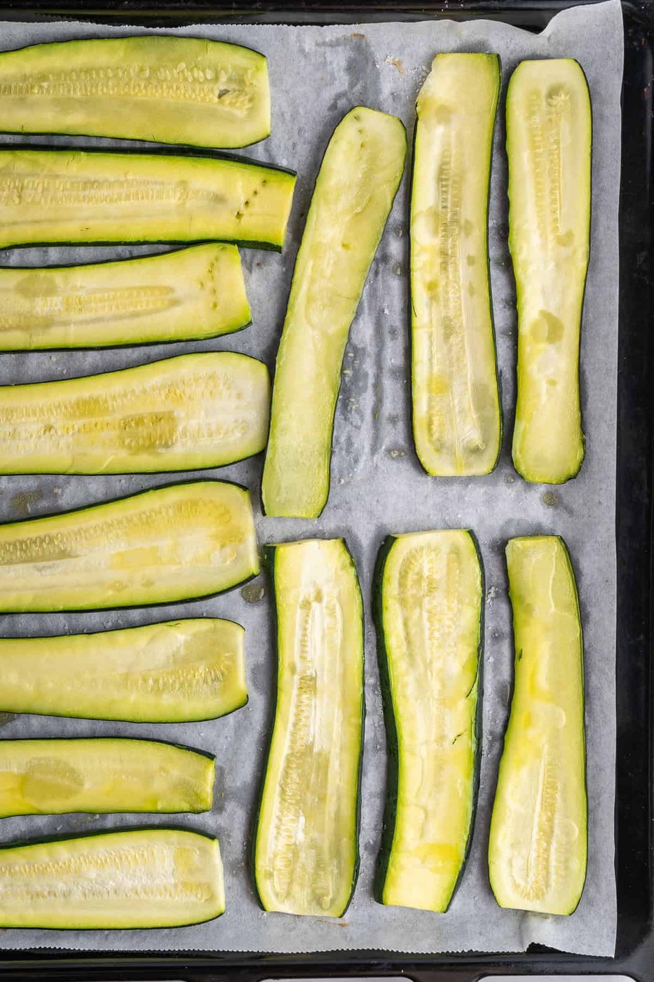 Picture of the zucchini on a baking sheet drizzled with olive oil 