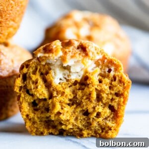 Top-down view of a freshly baked pumpkin cream cheese muffin