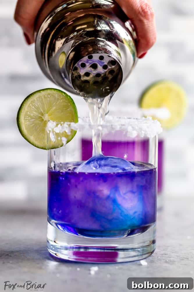 Magical Color Changing Margarita in a glass, transitioning from blue to purple