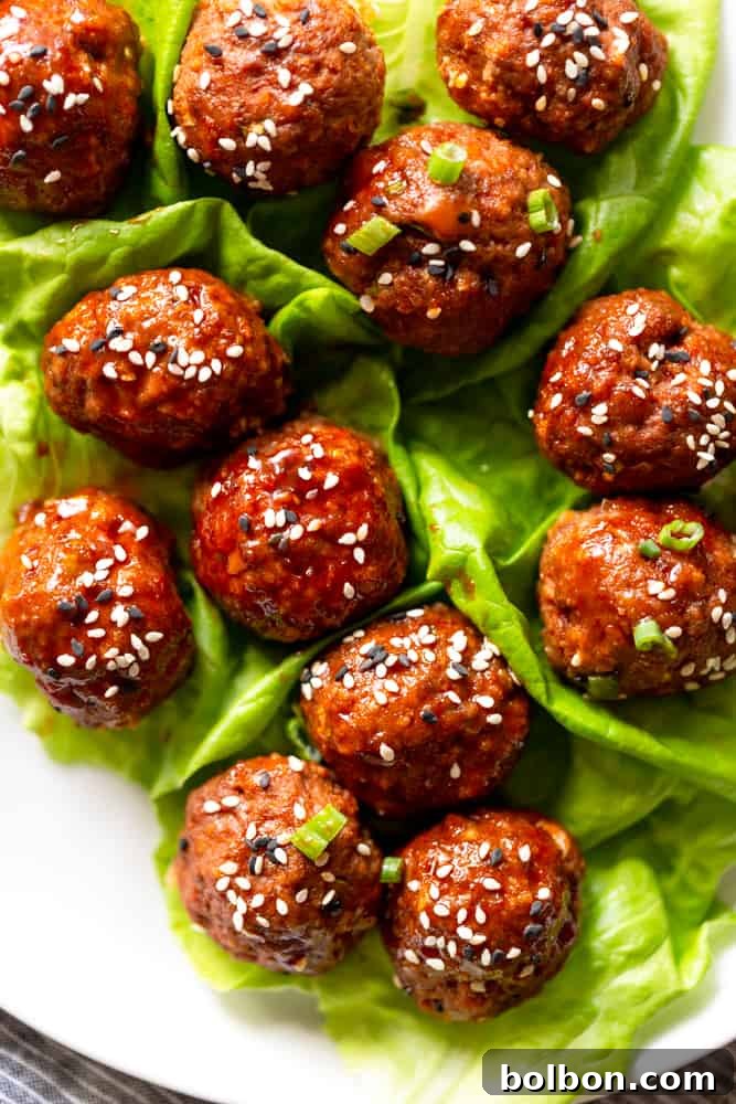 Korean Meatballs Made Easy 10 A delicious plate of sweet and spicy Korean meatballs, garnished with sesame seeds and green onions, ready to be enjoyed.