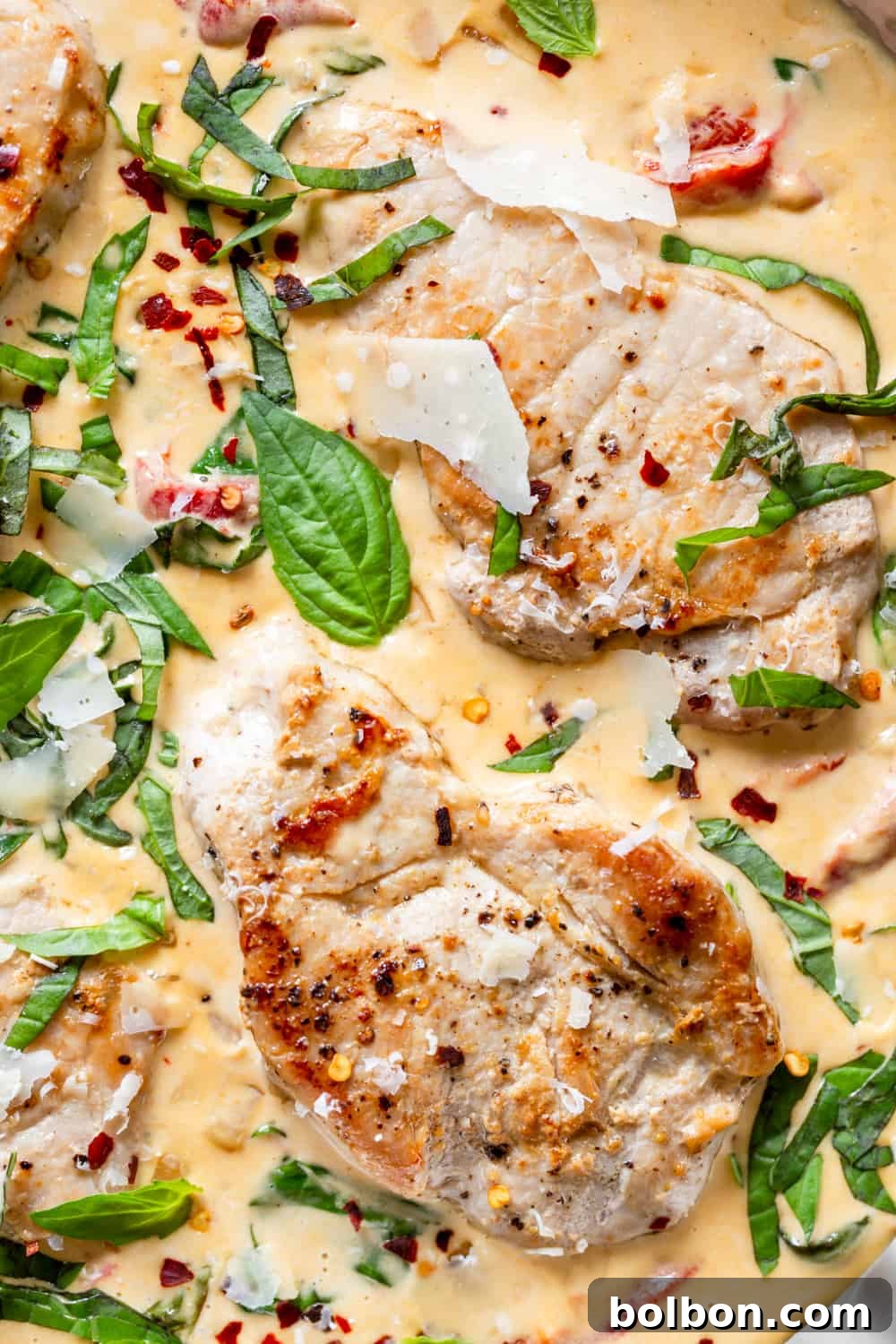 Close-up of perfectly seared boneless pork chops before adding the creamy sauce.