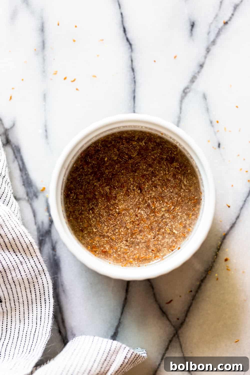 Gelatinous flax egg mixture in a white bowl, showcasing its binding consistency.