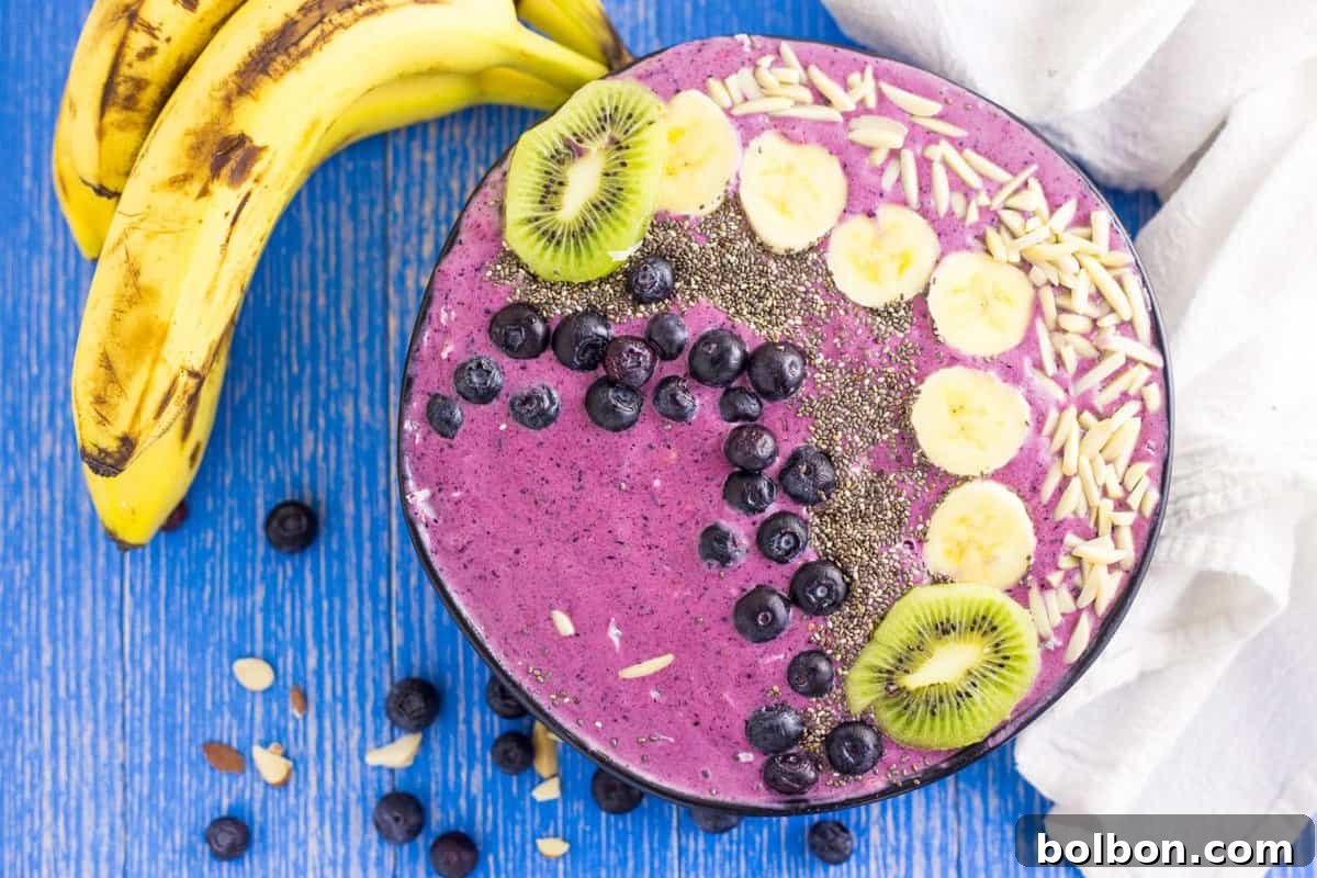 Banana Blueberry Smoothie Bowl topped with granola and fresh berries