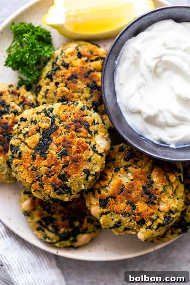 Golden brown White Bean and Kale Patties served on a white plate, garnished with fresh herbs and ready to be enjoyed as a healthy vegetarian meal.