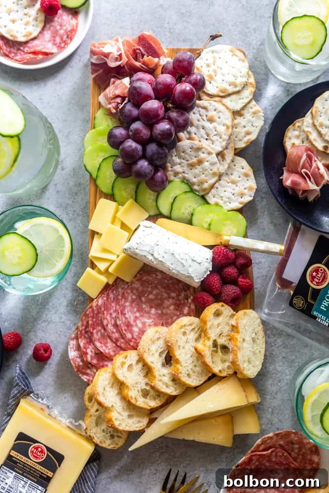 Close-up of a meat and cheese board featuring grapes and other delicacies