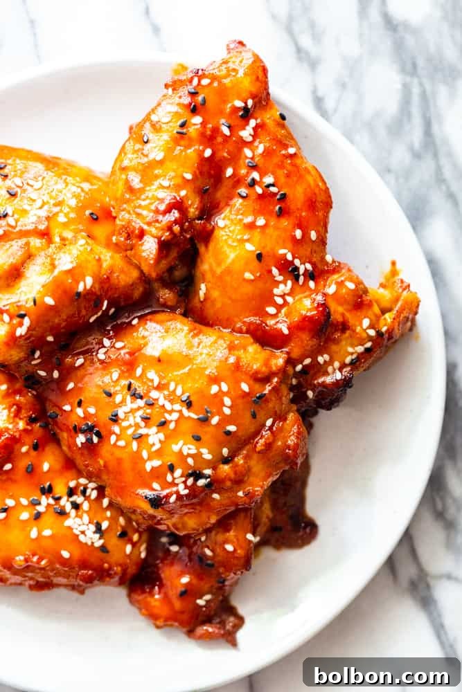 Sticky Korean Chicken Thighs on a white plate closeup