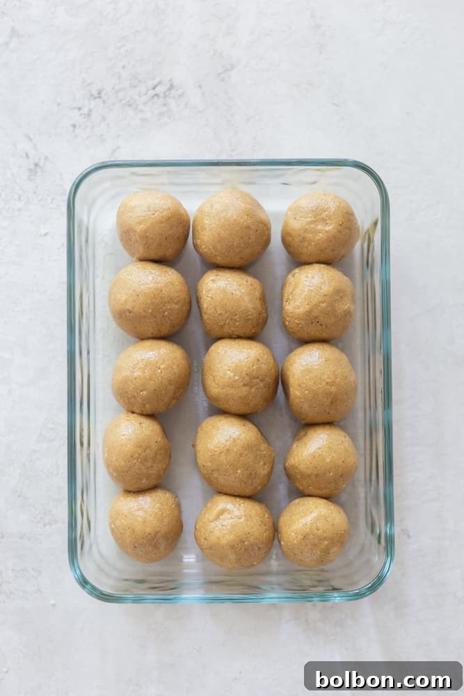 Honey-Sweetened Peanut Butter Power Bites 6 A glass container filled with freshly made peanut butter energy balls, showing ideal storage for meal prep