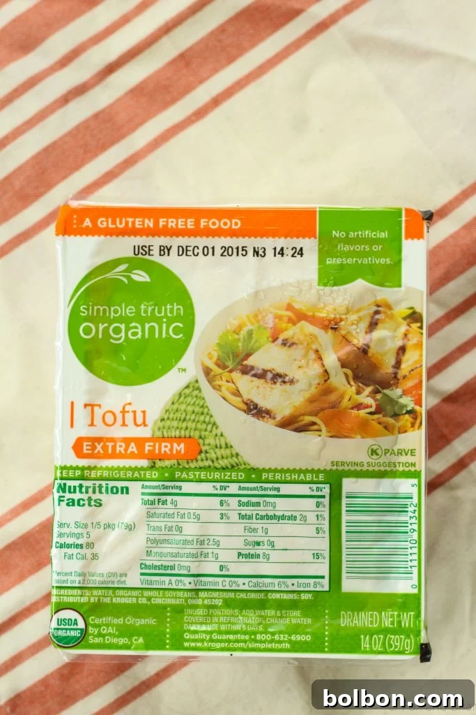Perfect Tofu Secrets 4 A block of extra-firm tofu being frozen, still in its original packaging, ready for transformation.
