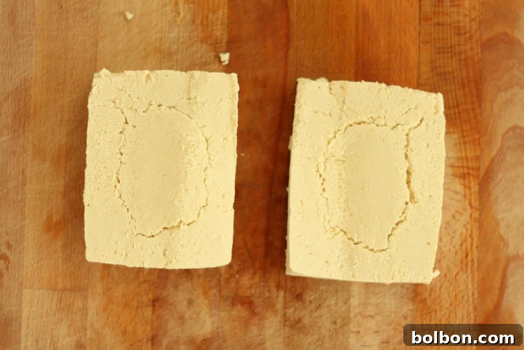 Perfect Tofu Secrets 7 Two long, thin slabs of tofu after being sliced lengthwise, ready for the next cut.