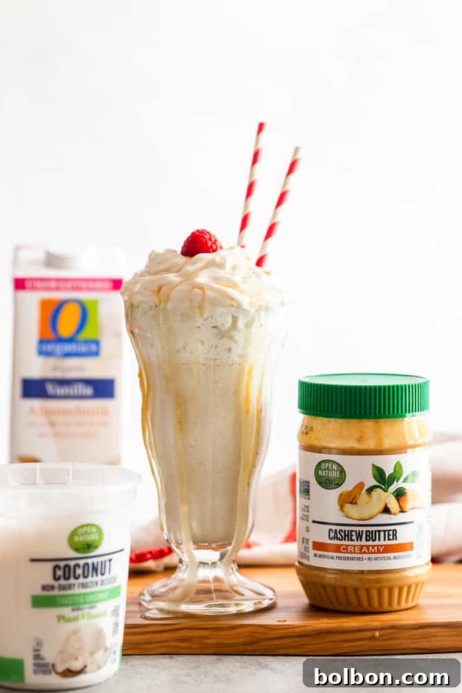 A glass of vegan milkshake ready to be enjoyed, with a spoon resting in it.