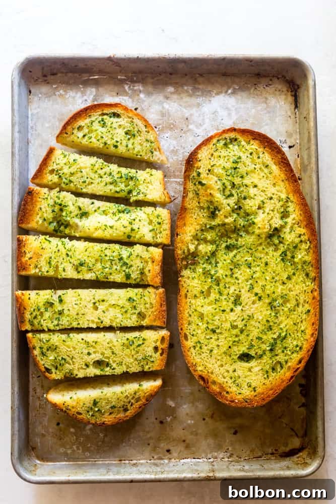 The Ultimate Easy Garlic Bread 6 Freshly baked garlic bread on a baking sheet, with a golden brown crust