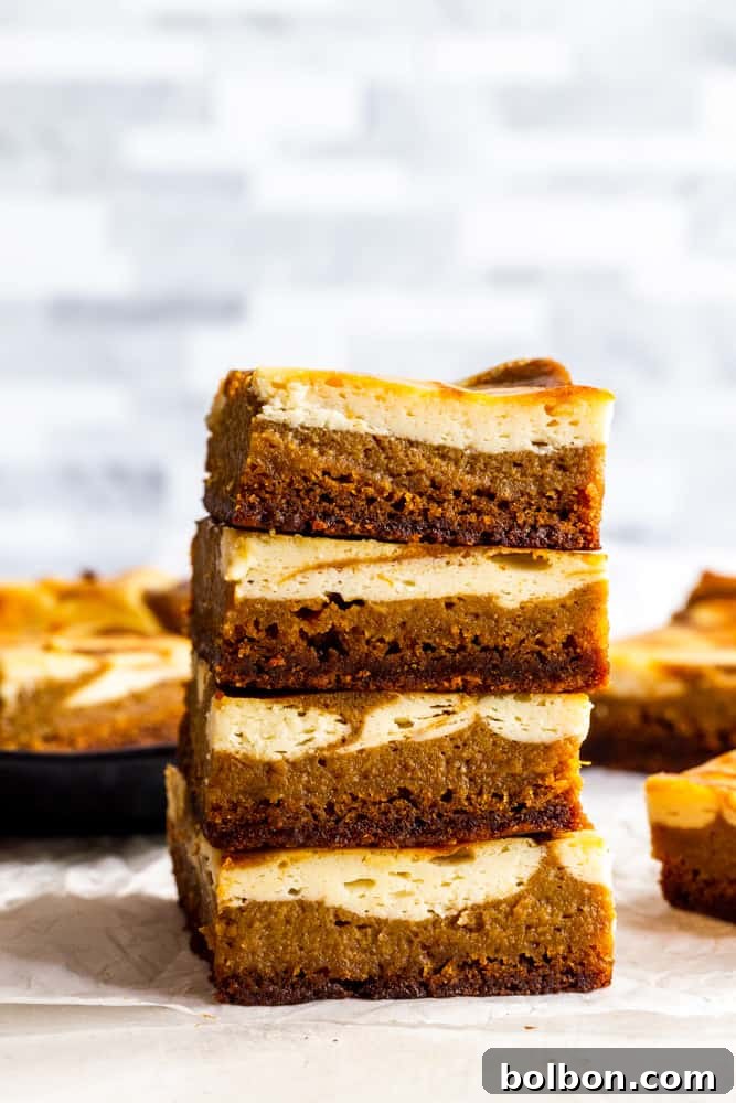 Stacked Pumpkin Cream Cheese Bars with a gingersnap crust, pumpkin filling, and cream cheese swirl, ready for a fall party. Keywords: fall dessert, pumpkin recipes, cream cheese bars, gingersnap crust, easy pumpkin dessert.