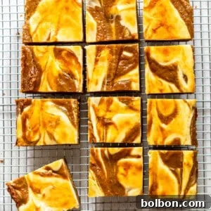 Finished Pumpkin Cream Cheese Bars with a creamy swirl