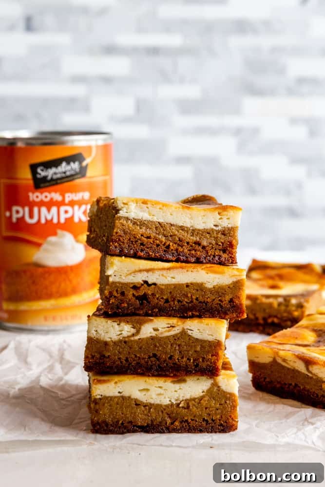 A beautifully arranged stack of Pumpkin Cream Cheese Bars on a white plate, showcasing the distinct layers and elegant cream cheese swirl. Keywords: pumpkin cream cheese bars stack, ready to serve, fall dessert plating, delicious treats.