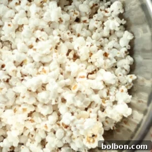 A vibrant bowl of freshly popped stovetop popcorn, ready to be enjoyed.