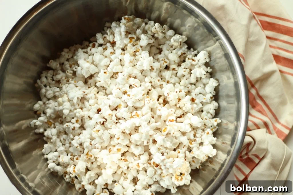 The ultimate reward: a generously buttered and salted bowl of homemade stovetop popcorn, ready for movie night.