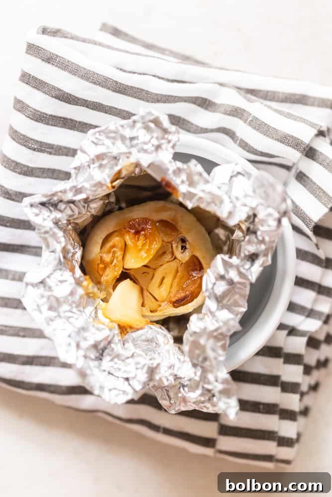 Roasted head of garlic wrapped in foil.