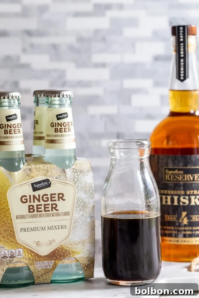 Ingredients for Gingerbread Irish Mule laid out, featuring Safeway's Signature RESERVE Whiskey and Signature SELECT Ginger Beer.