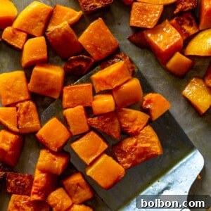 Roasted butternut squash cubes on a baking sheet, ready to serve.
