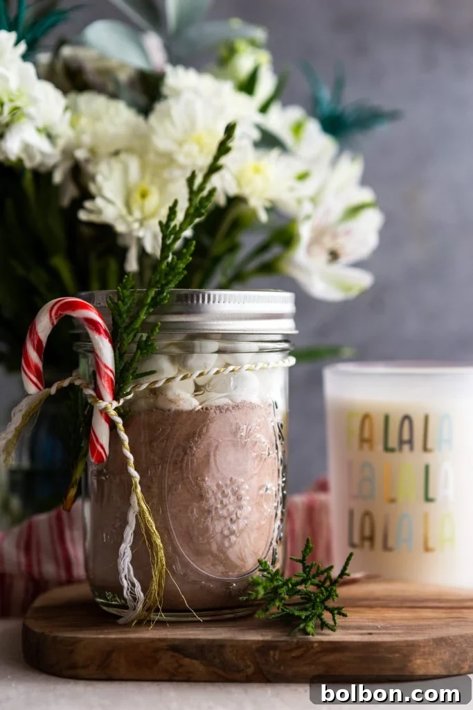 Craft Your Own Perfect Hot Chocolate Blend 5 A festive care package with homemade hot chocolate mix, a bouquet of flowers, and a holiday candle.