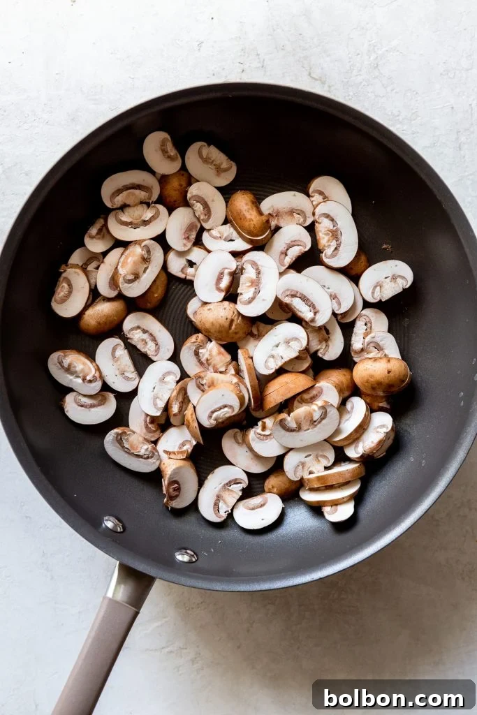 Perfectly sliced crimini mushrooms, ready to be dry-sauteed for maximum flavor in the pasta dish.