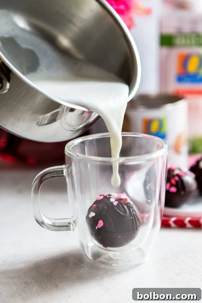 Crafting Irresistible Hot Chocolate Bombs 2 A perfectly formed hot chocolate bomb resting in a clear glass mug, ready for hot milk to be poured over it, promising a magical chocolate experience.