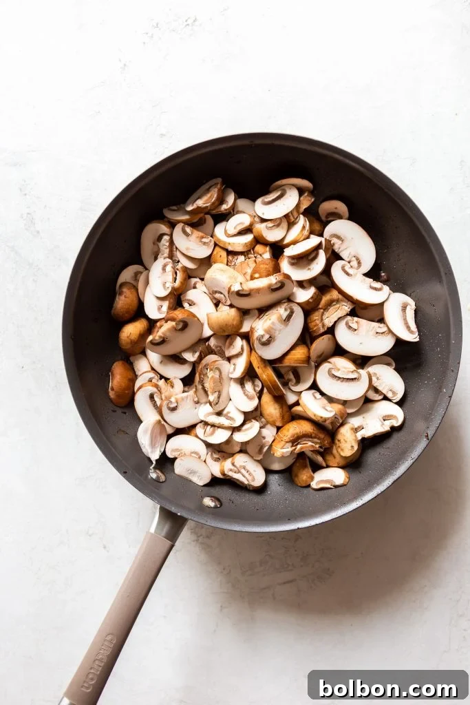 Sliced mushrooms ready for sautéing in Beef Stroganoff.
