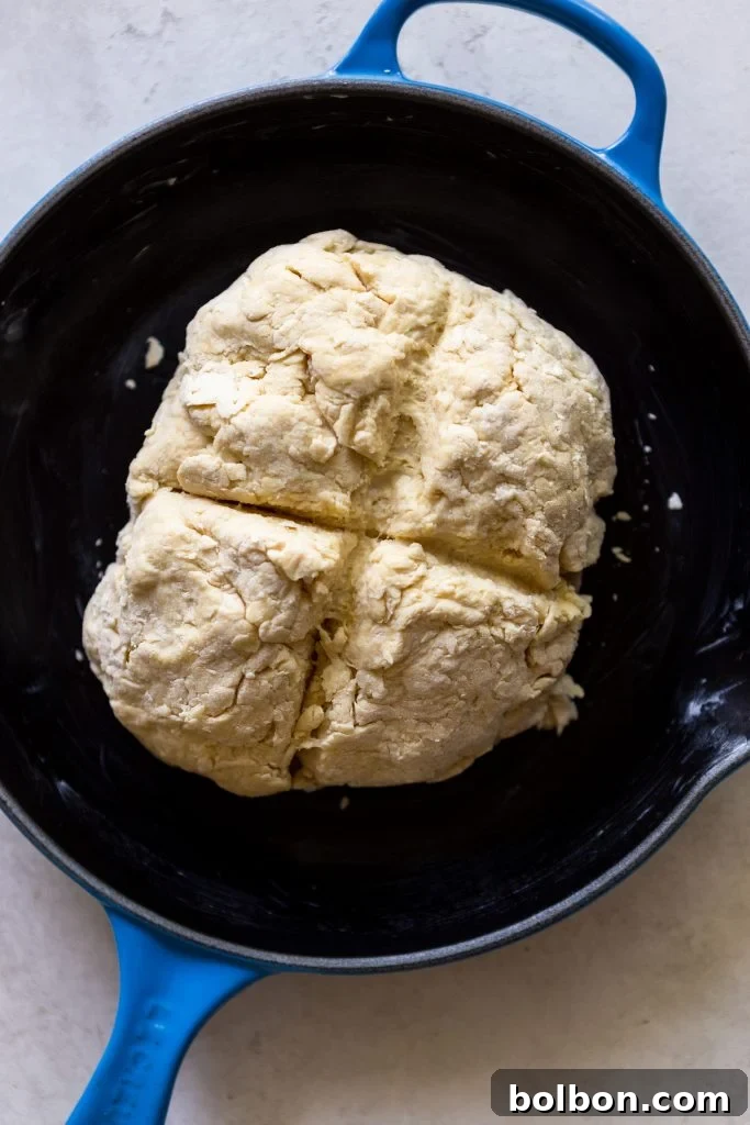 The Quintessential Irish Soda Bread 4 A slice of Irish Soda Bread with butter and jam, ready to be enjoyed.