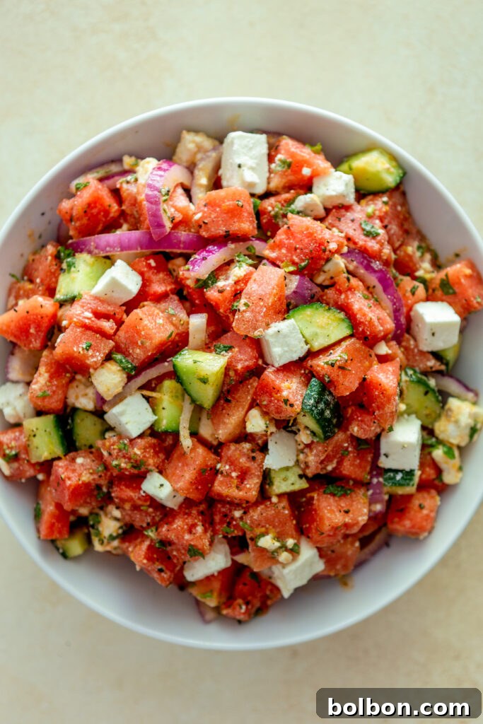 Sweet and Savory Watermelon Feta Salad 5 The finished Watermelon Feta Salad, beautifully presented in a clean white bowl, ready to be served. The colors are vibrant and inviting.