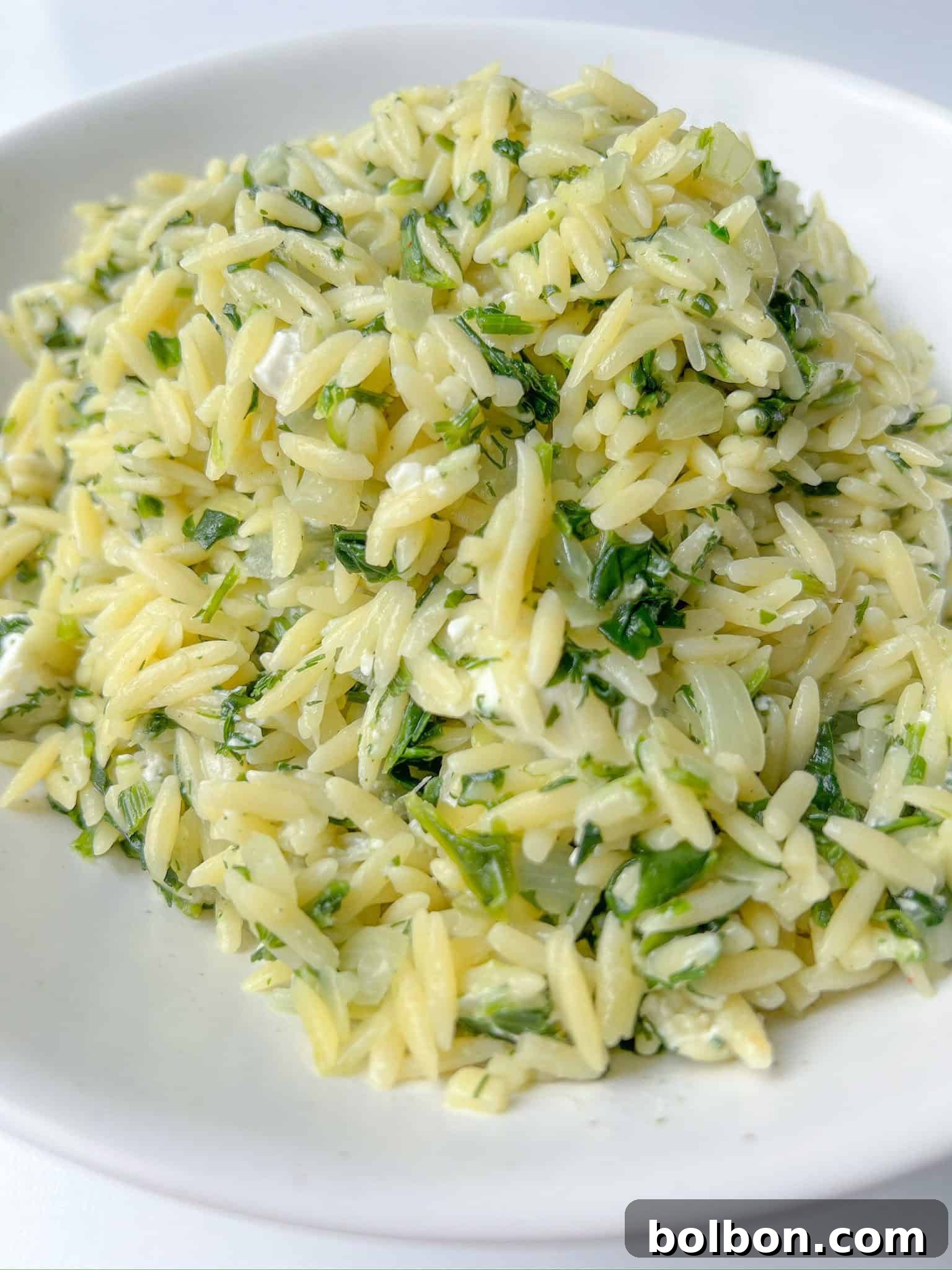 Spinach and Feta Orzo, ready to serve in a rustic bowl.