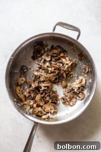 Mushrooms and spices cooking in a pan.