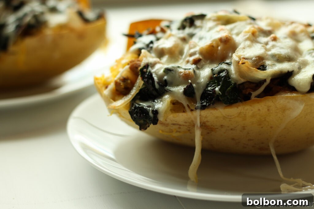 Delicious Sausage and Kale Spaghetti Squash Boats topped with melted cheese, a perfect low-carb, gluten-free meal.