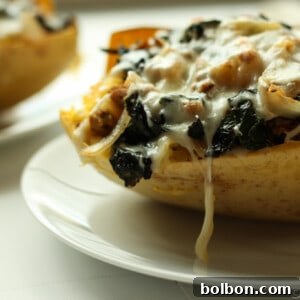 Sausage and Kale Spaghetti Squash Boats! So good! And healthy! Spicy Sausage and Garlicky Kale all topped with melty cheese make this low carb and gluten free meal perfectly satisfying.