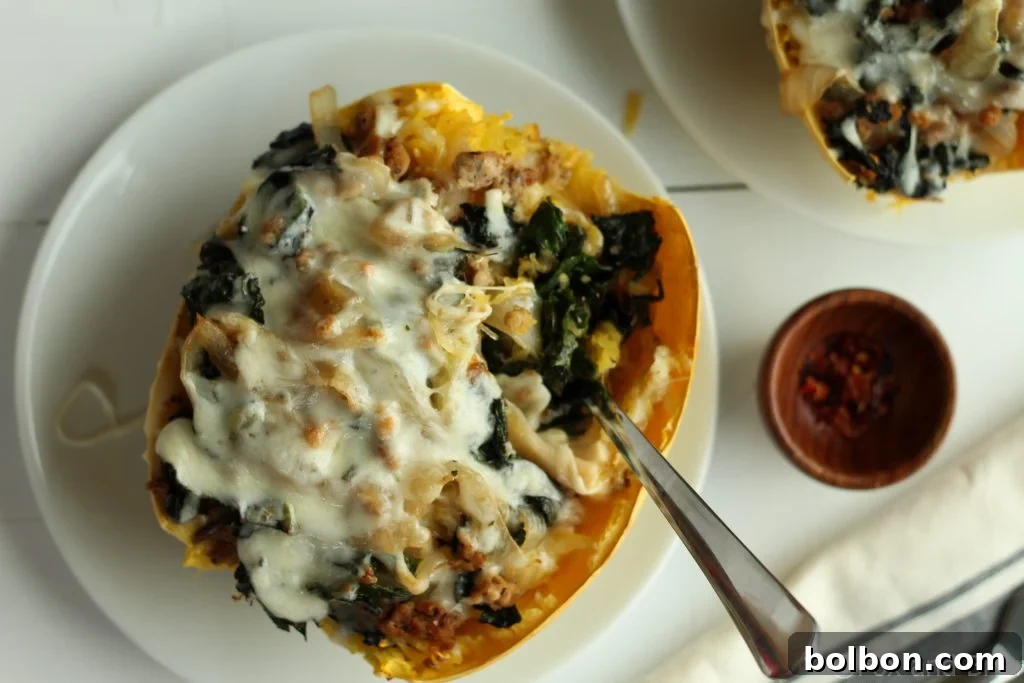 Beautifully plated Sausage and Kale Spaghetti Squash Boat, ready to be enjoyed.