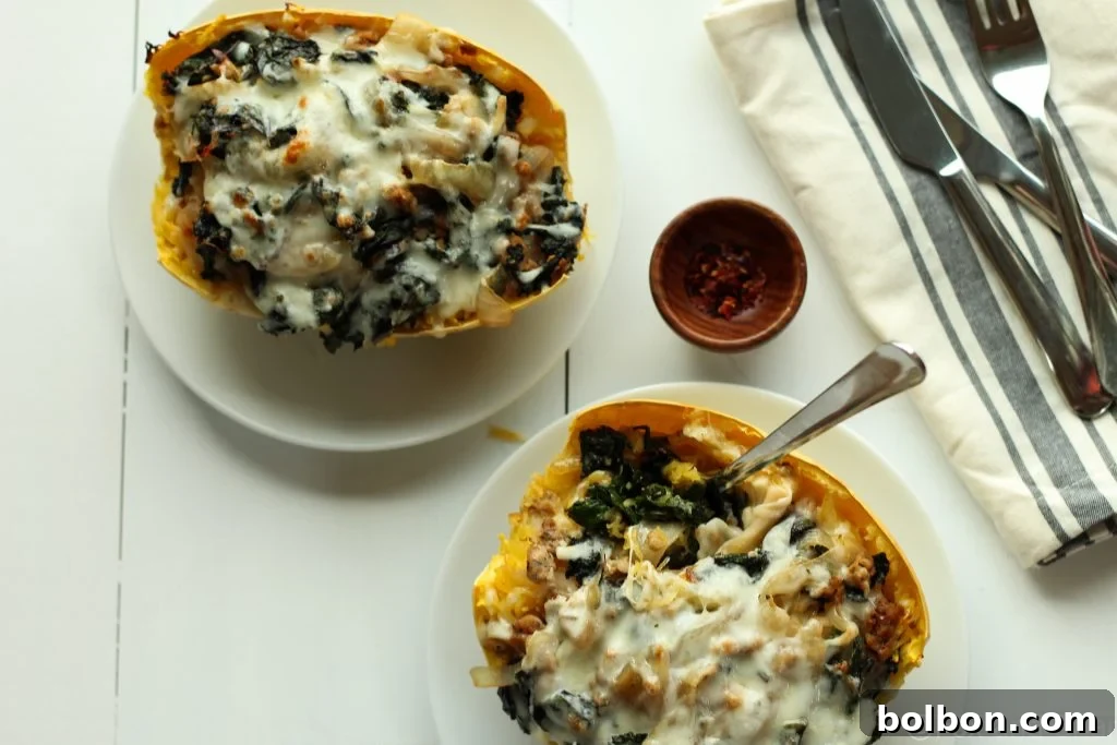 Two Sausage and Kale Spaghetti Squash Boats in a baking dish, fresh from the oven.