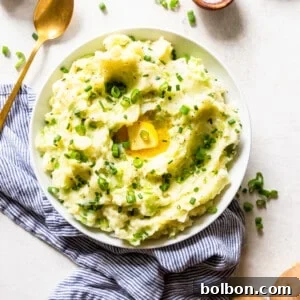 Colcannon served in a bowl with a pat of butter and green onions