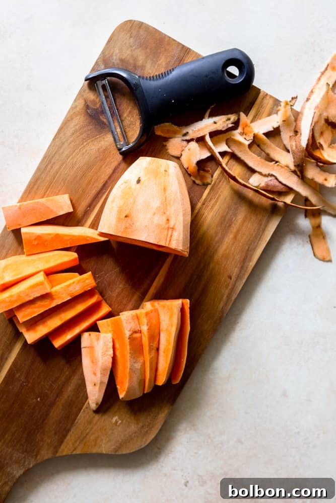 Sweet potato planks being cut into uniform sticks.