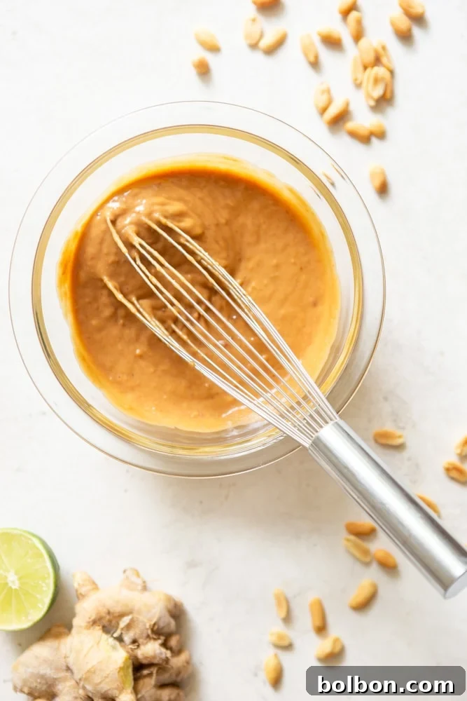Zesty Peanut Noodles 4 Peanut Sauce for cold noodle salad in a glass bowl.