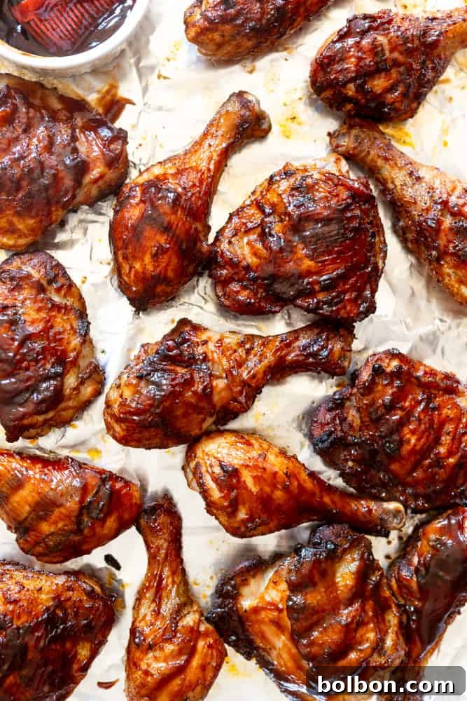 A vibrant platter showcasing grilled BBQ chicken thighs and drumsticks, perfectly cooked with a rich, inviting glaze. The chicken is arranged artfully, ready to be served, emphasizing its deliciousness and a successful grilling session.
