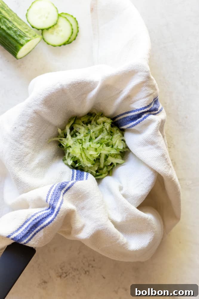 grated cucumber draining on a kitchen towel