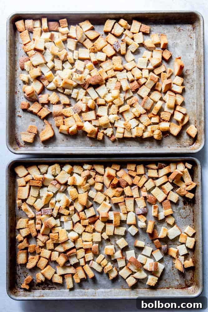 Timeless Savory Sausage Stuffing 4 Toasted bread cubes on a baking sheet, golden and dry.