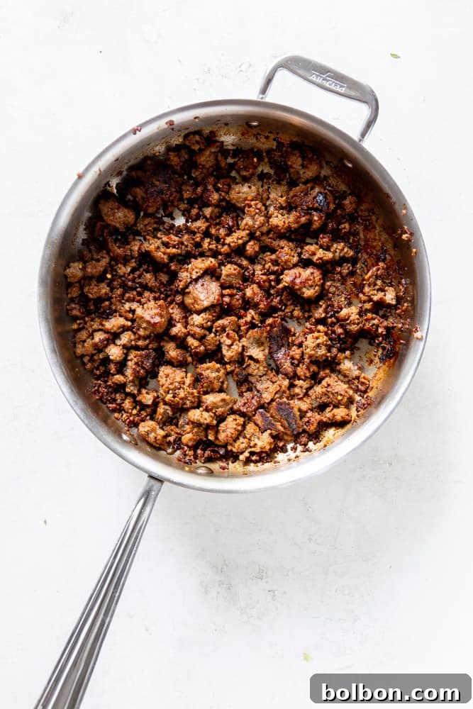 Timeless Savory Sausage Stuffing 6 Italian sausage browning in a large sauté pan.
