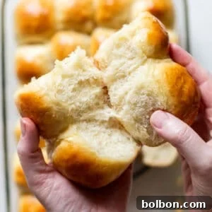 Effortless Dinner Rolls 11 Finished make-ahead dinner rolls on a wooden board.