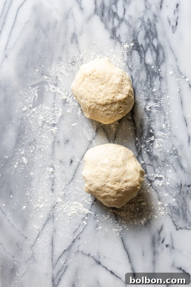 Effortless Dinner Rolls 4 Dough after being divided into two pieces.
