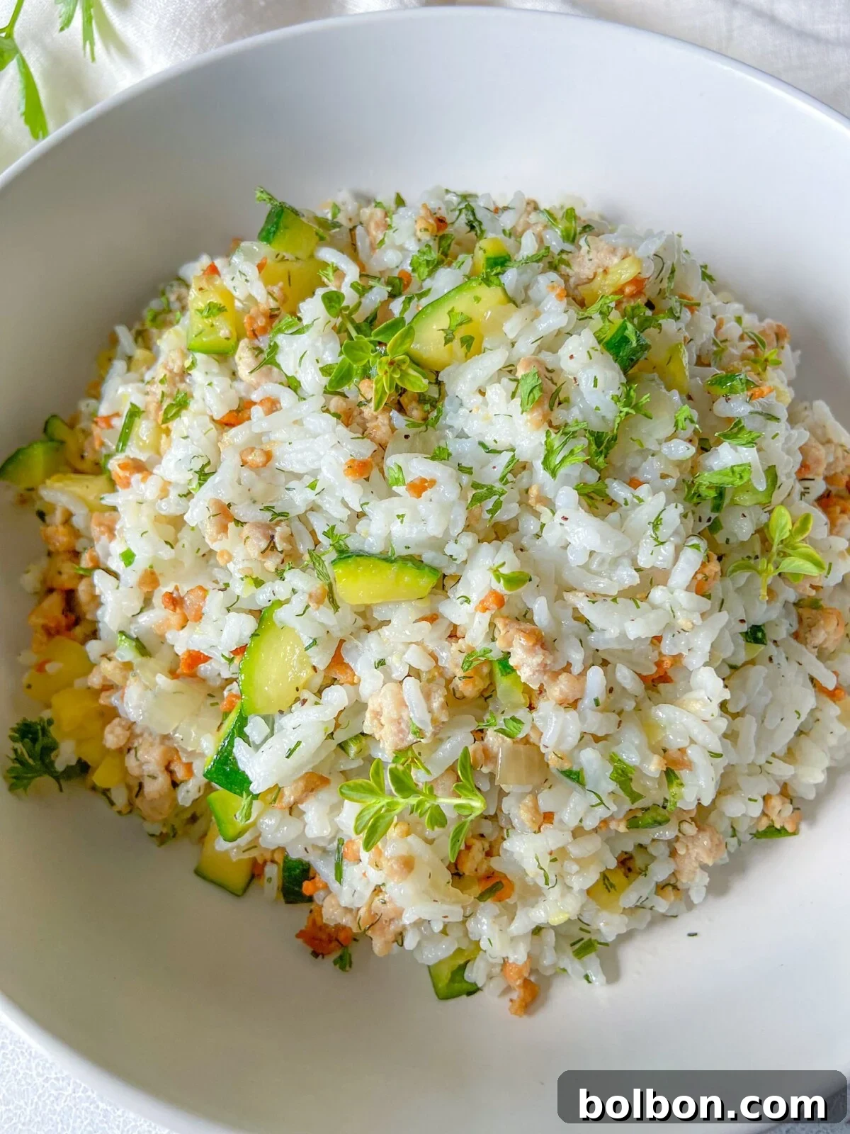 Hearty Zucchini Rice with Ground Meat, garnished with fresh herbs, ready to be served.