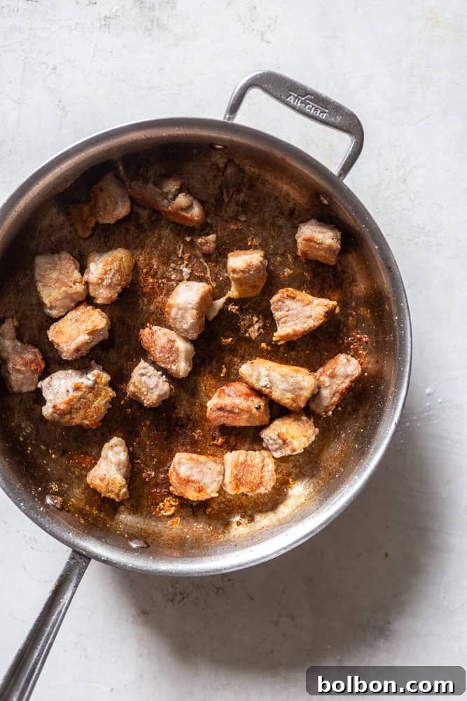 Sweet and Sticky Honey Garlic Pork Stir Fry 6 Pork being browned in a sauté pan.